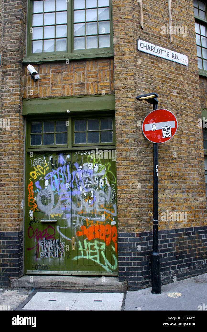 A doorway in Shoreditch covered in graffiti. Stock Photo