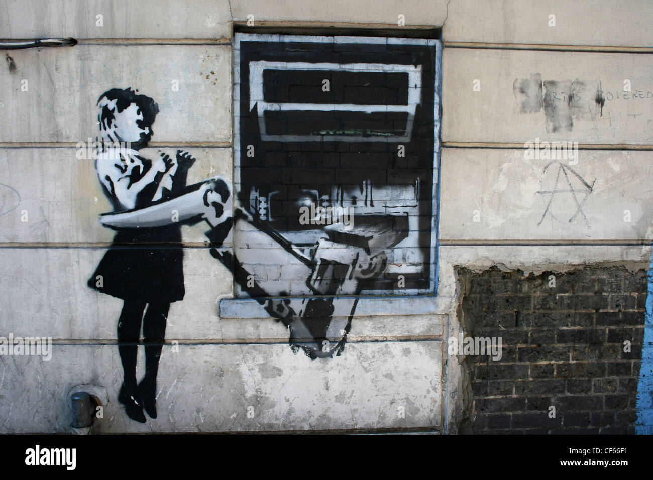 Cash machine graffiti by the artist known as Banksy. Stock Photo