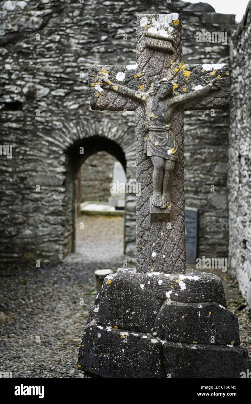 A stone crucifix in the historic ruins of Monasterboice founded in the late 5th century by St. Buite. Stock Photo