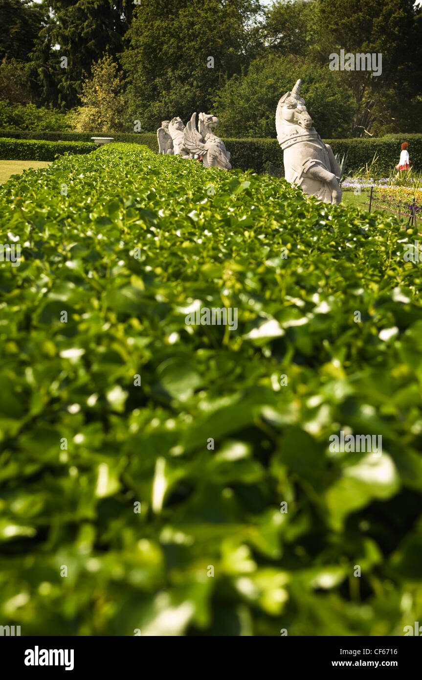 Granite statues in front of the Palm House at Kew Gardens. Stock Photo