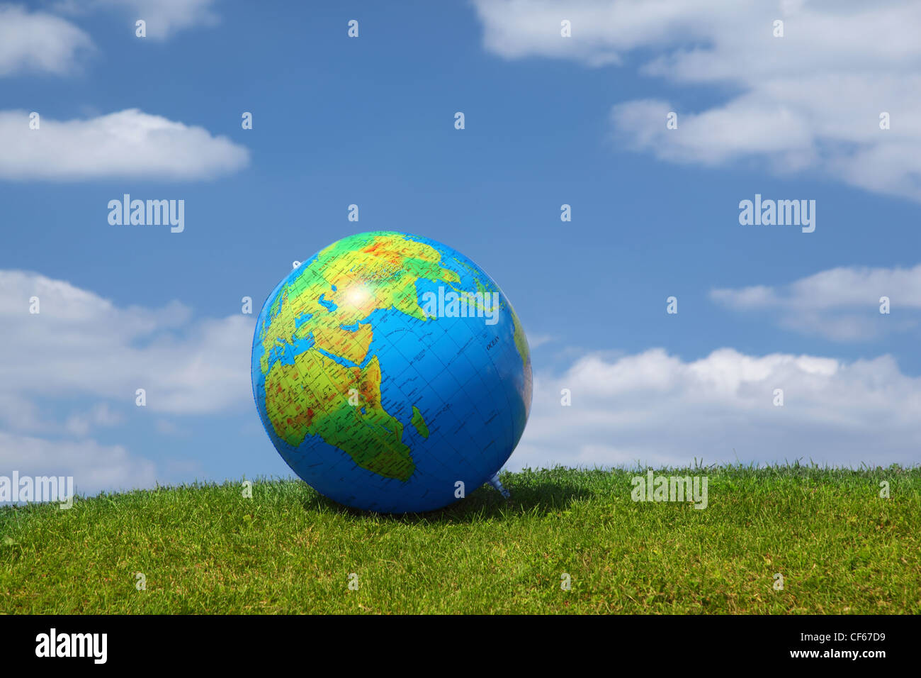 Large inflatable ball as  globe lies on  grass Stock Photo