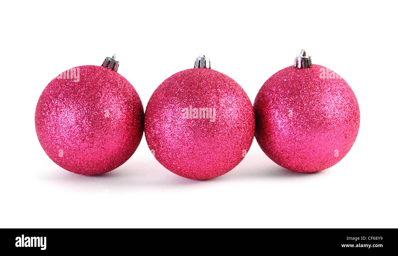 Three red Christmas tree balls lies in the range isolated on white Stock Photo