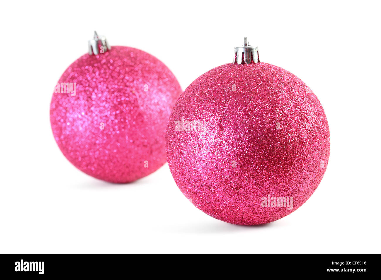 Two red Christmas tree balls isolated on white, focus on front ball Stock Photo