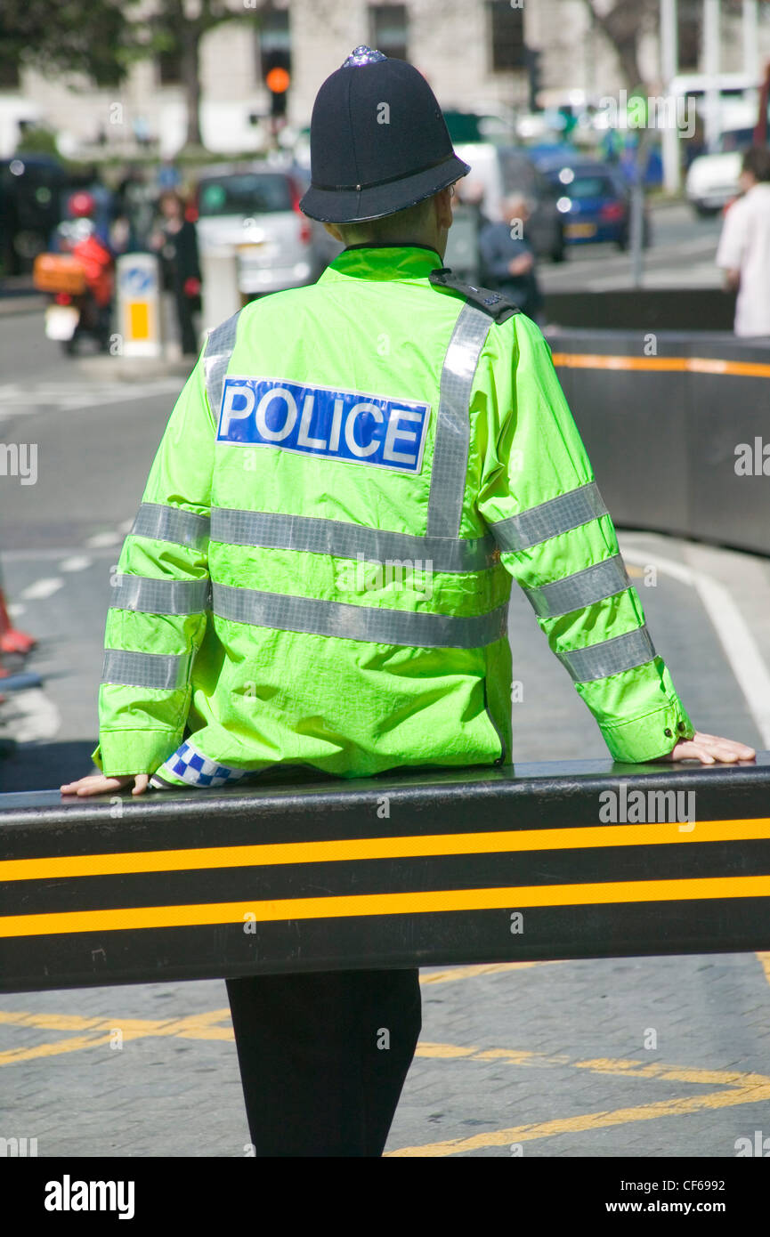 A Metropolitan Police Constable wearing a high visibility uniform and helmet. The Metropolitan police is London's biggest employ Stock Photo