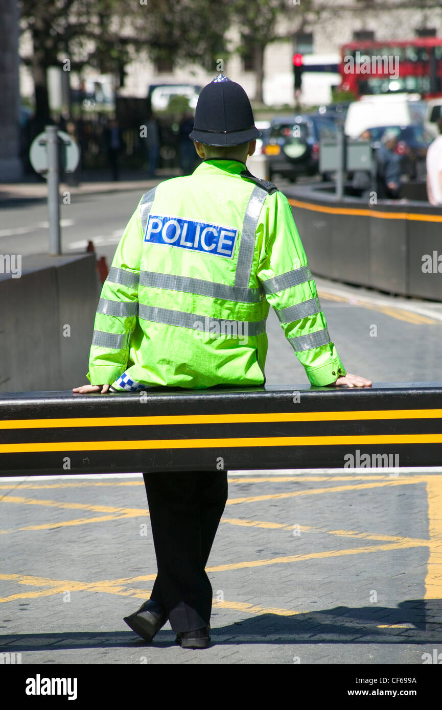 A Metropolitan Police Constable wearing a high visibility uniform and helmet. The Metropolitan police is London's biggest employ Stock Photo