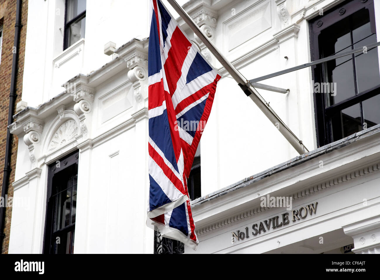 A Union Jack flag hangs above the entrance to number 1 Saville Row in