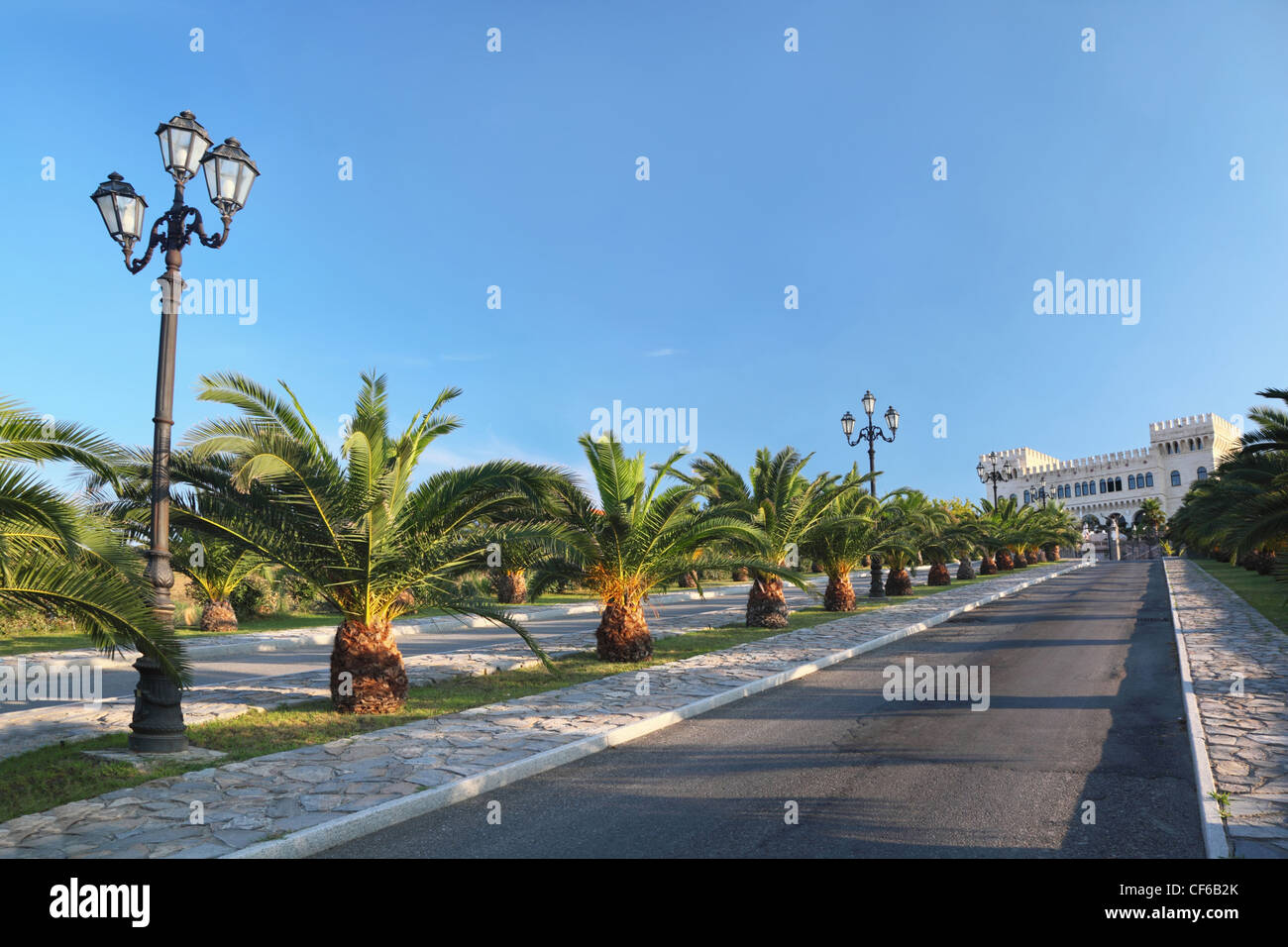 View on  palace at  end of street with palms and lanterns Stock Photo