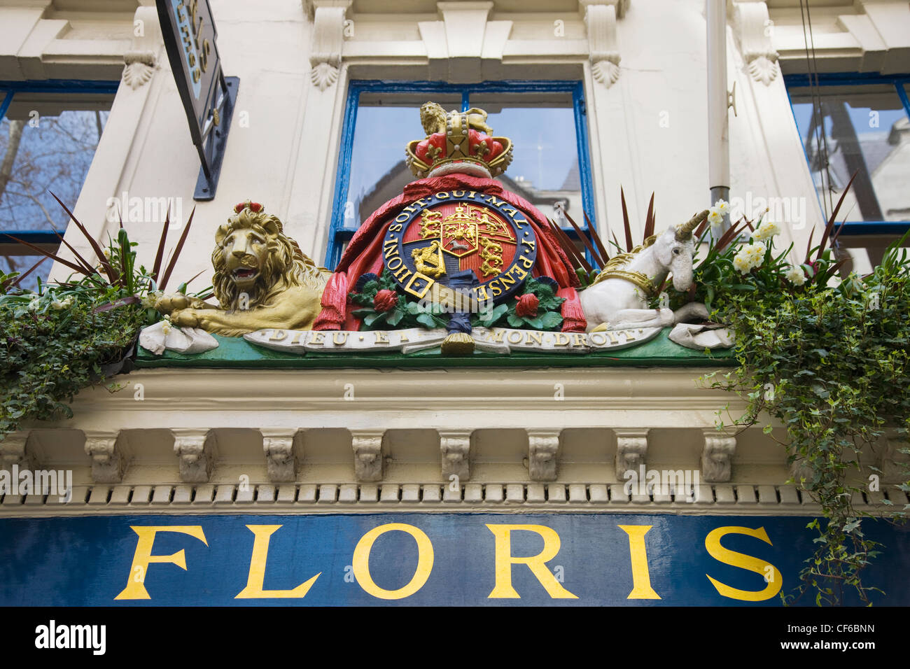 A statue emblem above the traditional shop front of a perfumer in Central London. Stock Photo