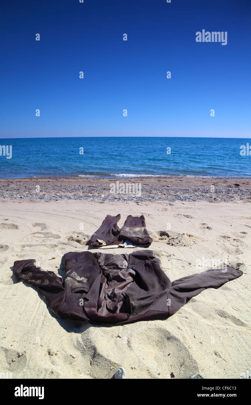 Business suit, trousers and jacket, lies on the coast and sprinkle by sand  Stock Photo - Alamy