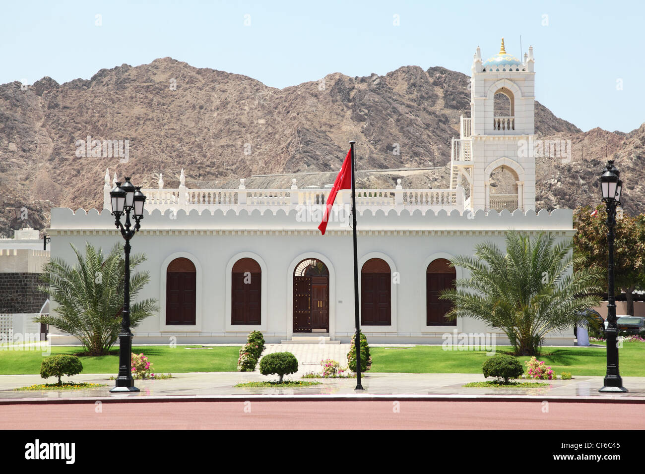 building inside Sultan's Palace in Oman. Flag in center of image. Stock Photo