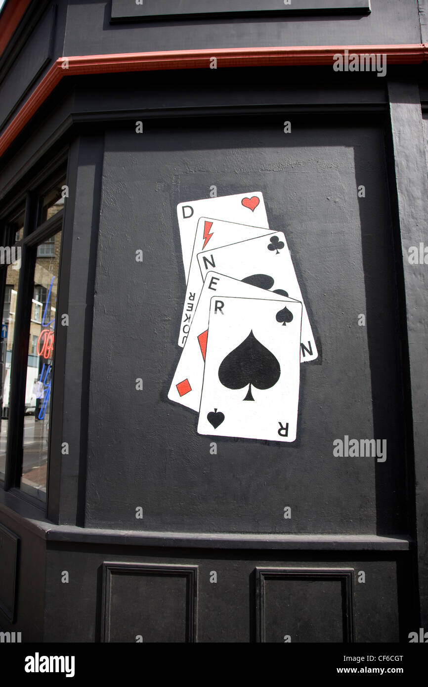 Playing cards painted on the wall of a restaurant spelling the word Diner. Stock Photo