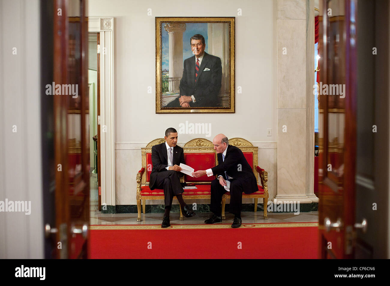 President Barack Obama talks with Chief of Staff Bill Daley in the Cross Hall of the White House March 3, 2011 in Washington, DC. Stock Photo