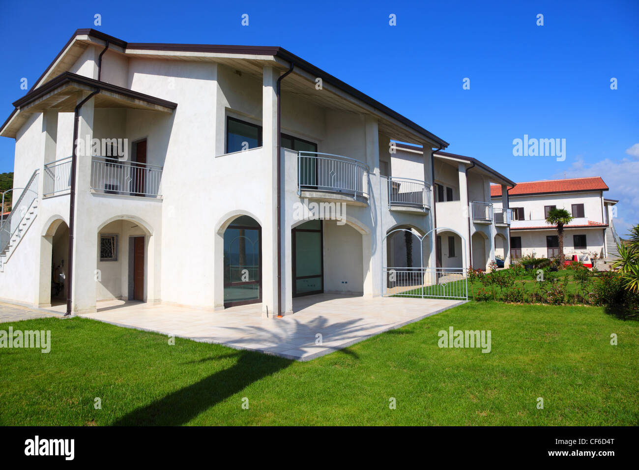 Facade of new white two-story house with garden, balcony and stairs Stock  Photo - Alamy