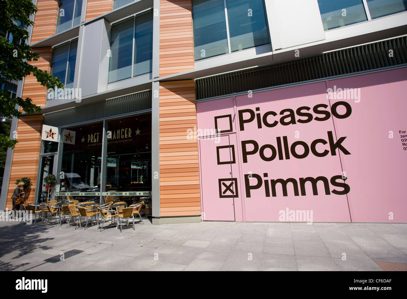 Pink shop signage reading 'Picasso Pollock Pimms' next to a Pret a Manger' cafe at Bankside Mix, a new urban destination in Sout Stock Photo