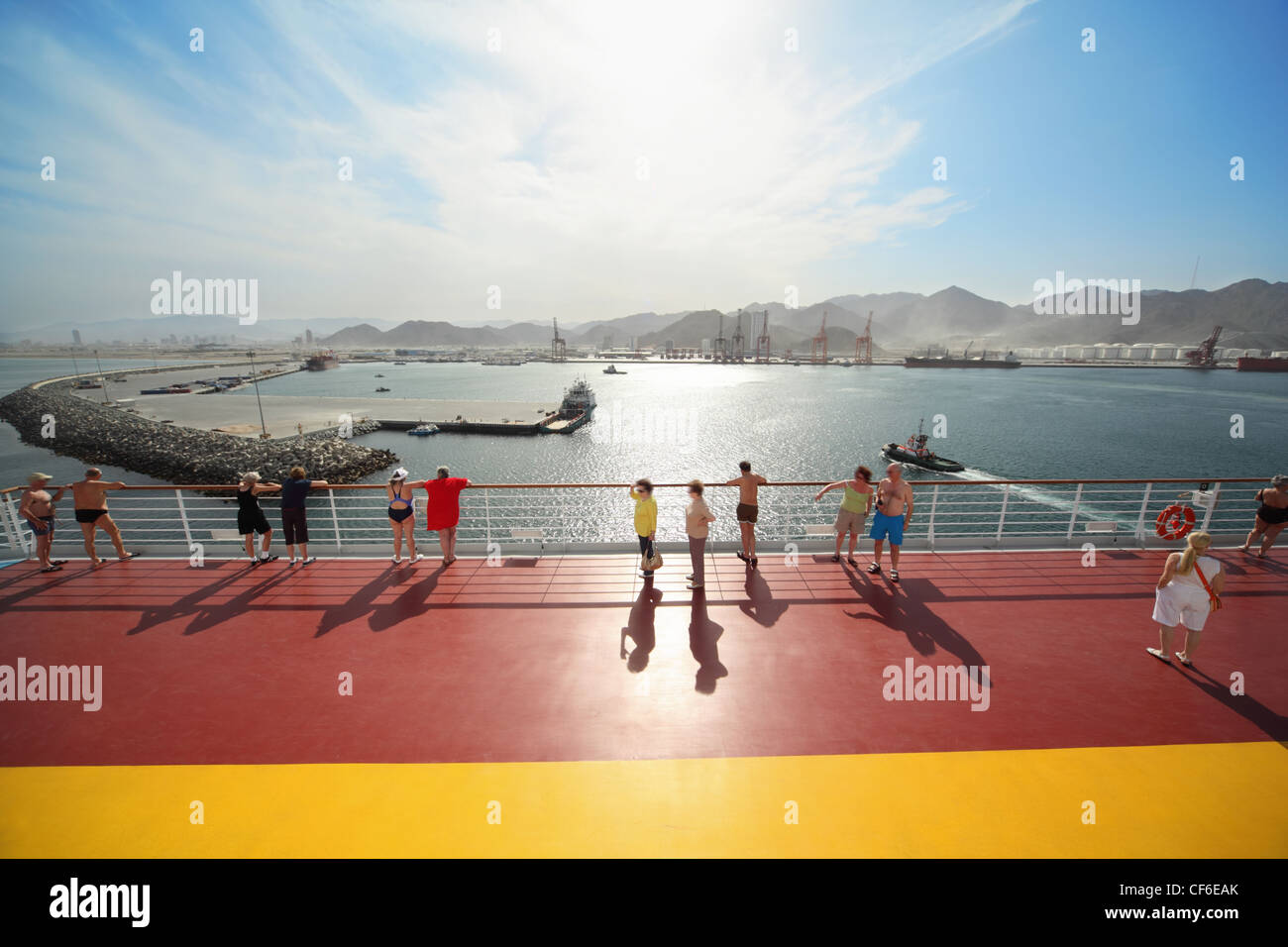 many people standing on deck of cruise ship. ships far away Stock Photo