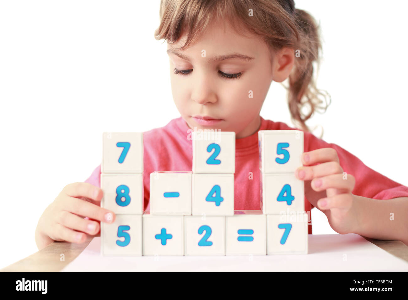 Little girl folds equalizations from cube Stock Photo Alamy