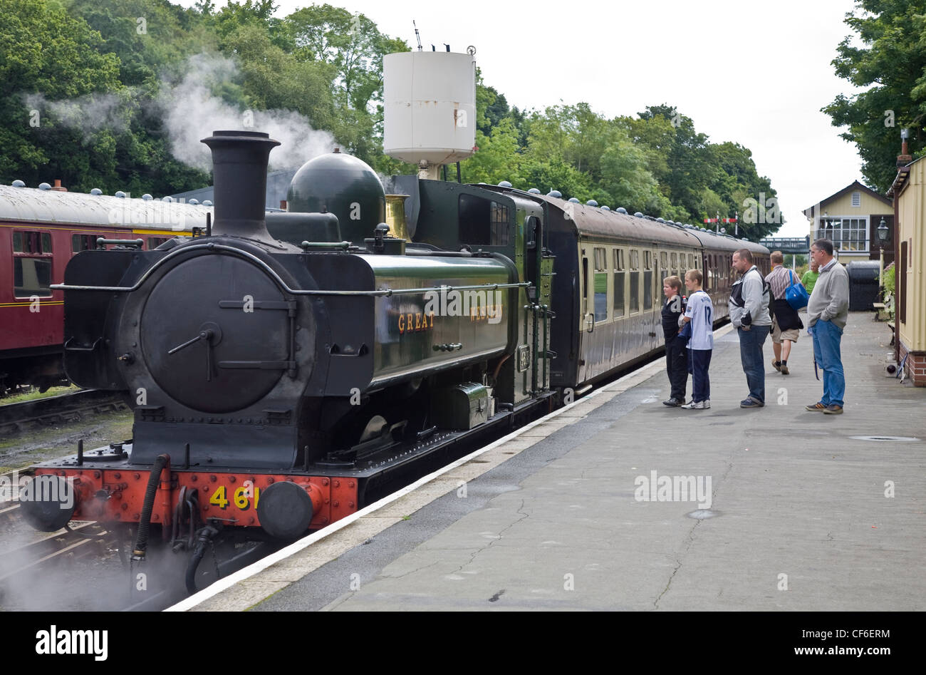 A family looking at a steam engine from a platform on the Bodmin and ...