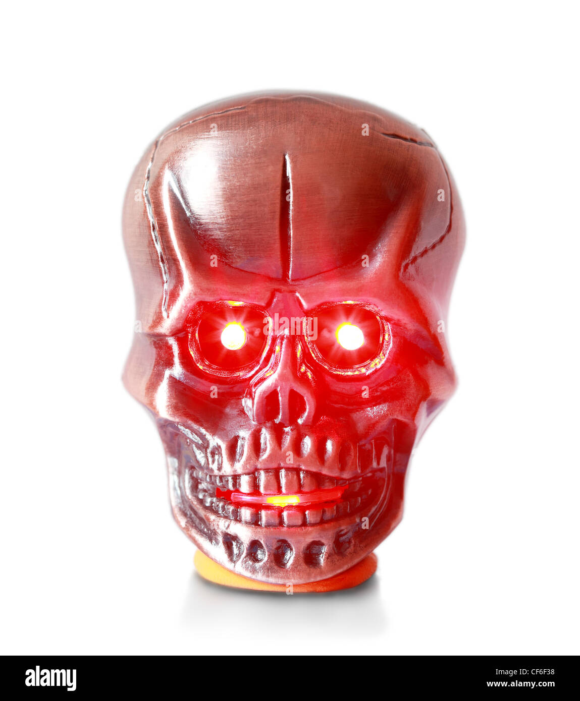 Lighter in the form metallic red skull on a pedestal with a glowing red eyes and mouth Stock Photo