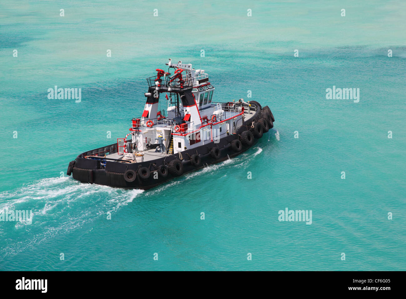 Pilot on little fire pusher tug drift through the sea at day Stock Photo