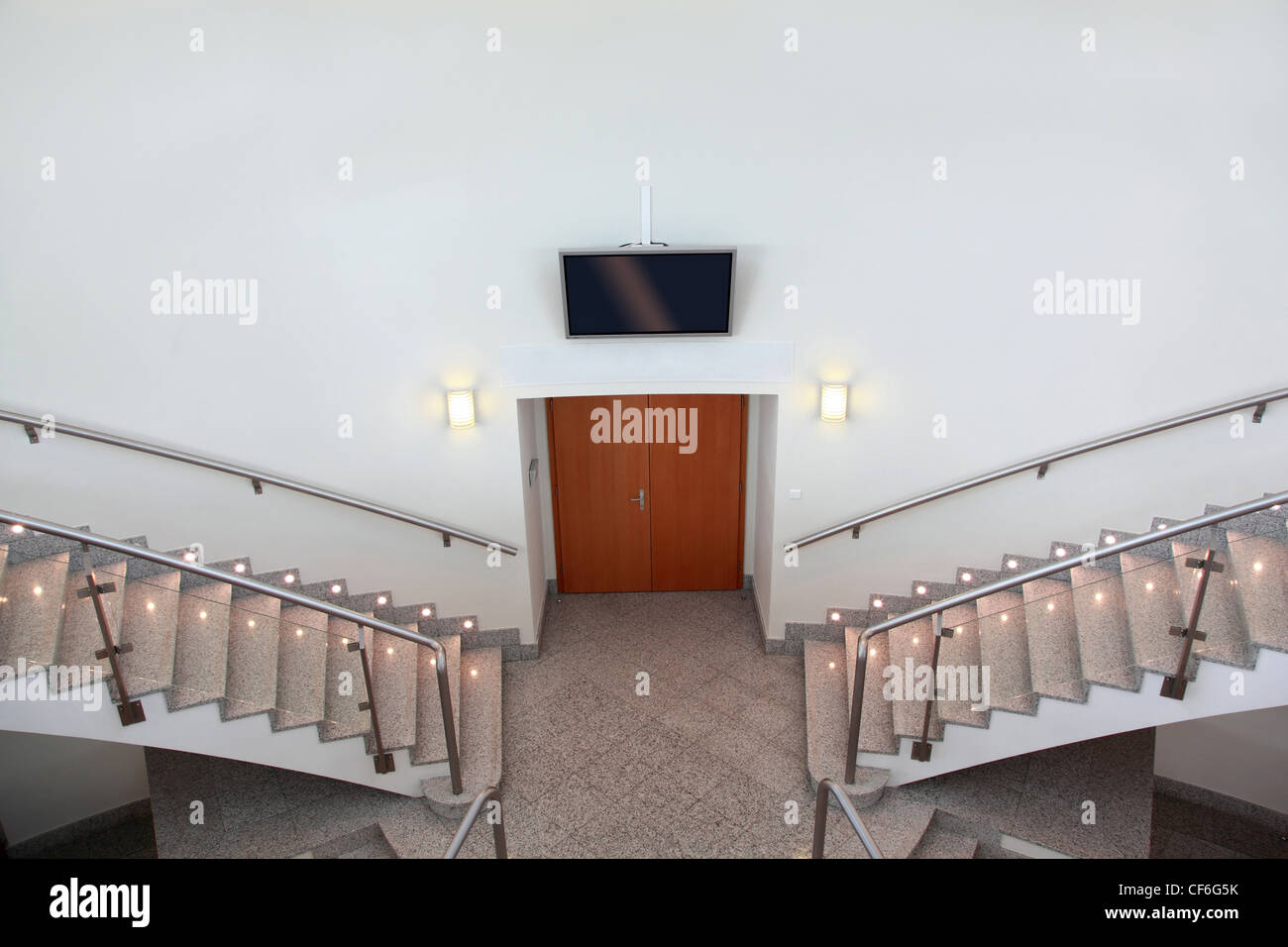Two ladder flights and front entrance in conference room Stock Photo