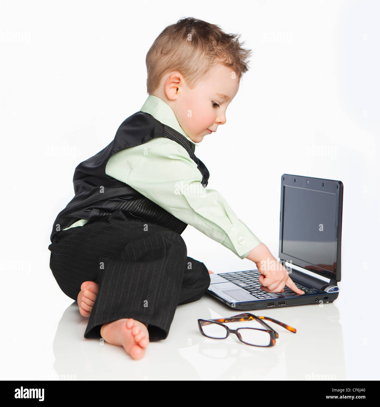 A Young Boy Dressed In A Suit Using A Laptop Computer; Edmonton Alberta ...