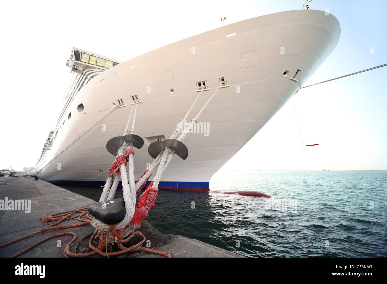 big white cruise ship standing in dock, mooring with ropes Stock Photo ...