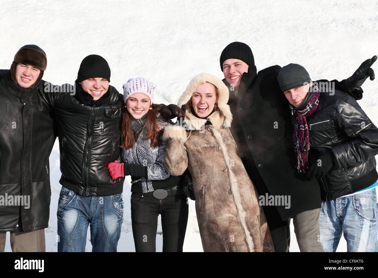 Students stand together hugging hands and laugh Stock Photo