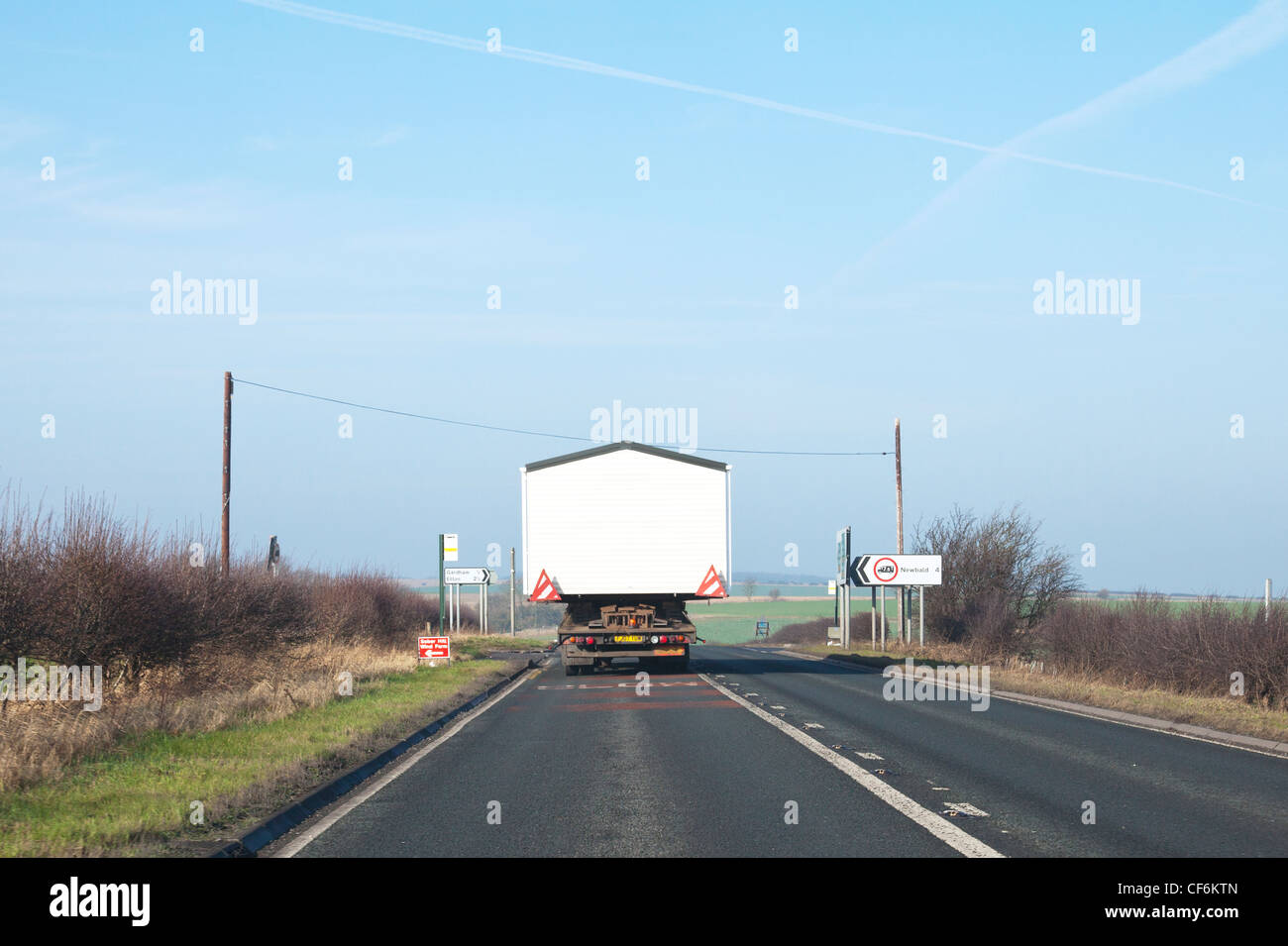York City, Yorkshire, England large static mobile home being transported by road on back of lorry truck to destination Stock Photo