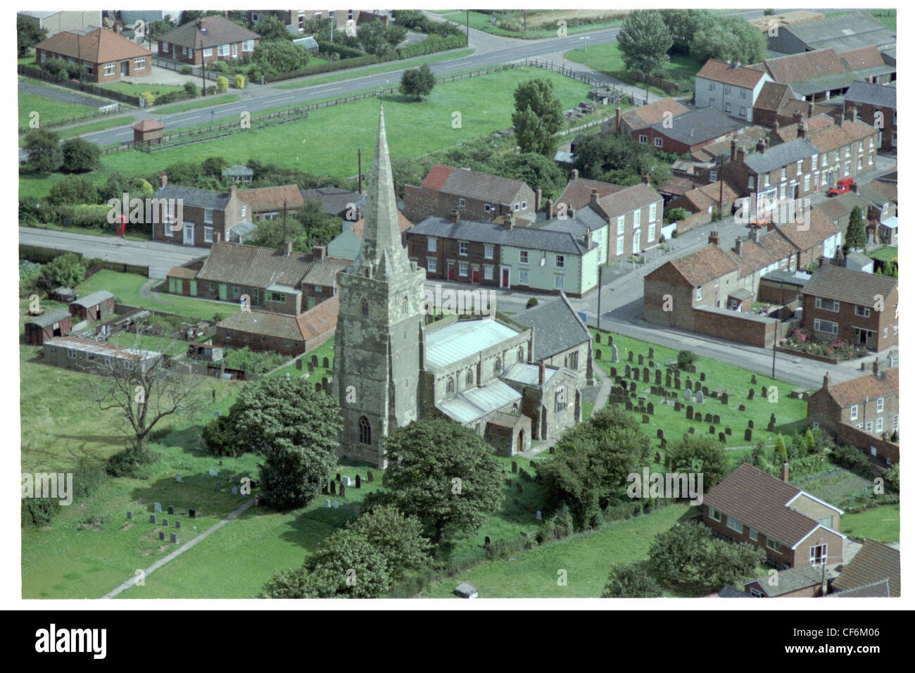 Oblique aerial photograph of the centre of the village of Ottringham in