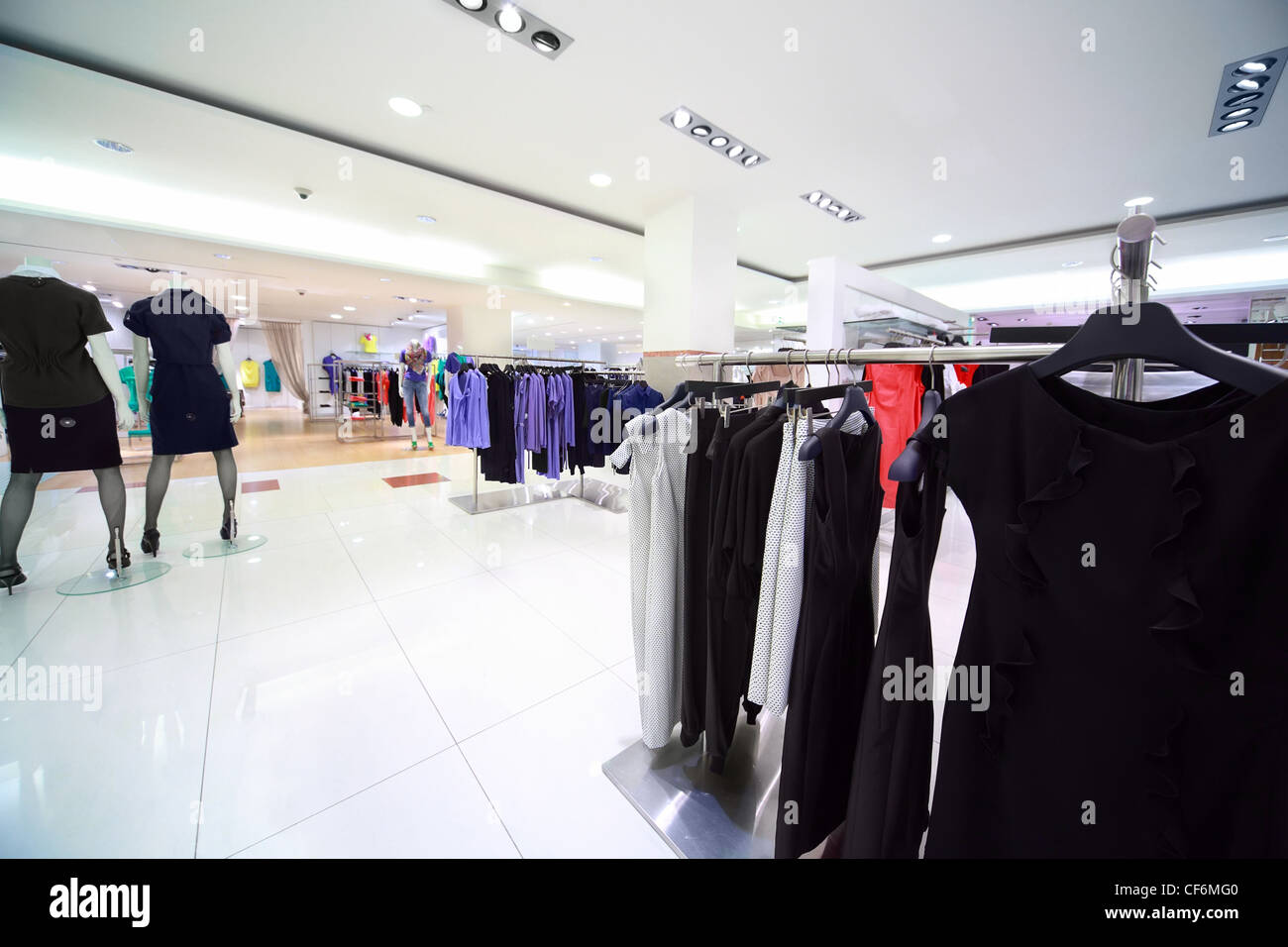 Large shop of womanish clothes, focus on peg on right in center Stock Photo