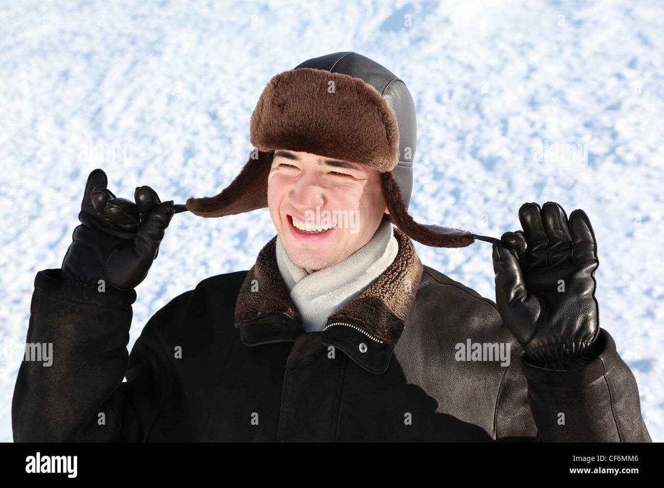 Boy holds on cordages ear-flaps hat Stock Photo