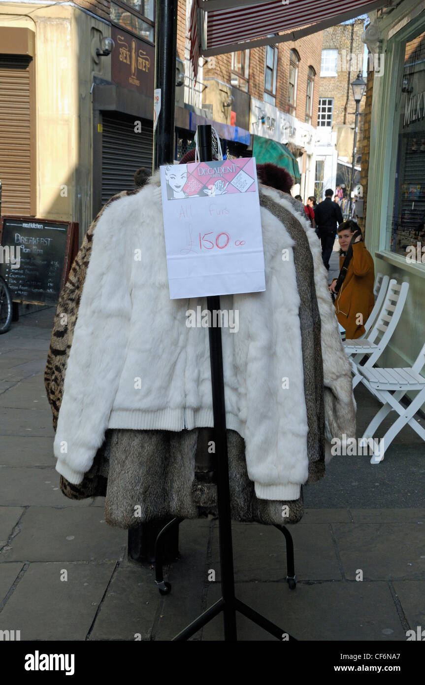Vintage fur coats for sale at £150 each on clothes rack outside shop in  Camden Passage Islington London England UK Stock Photo - Alamy