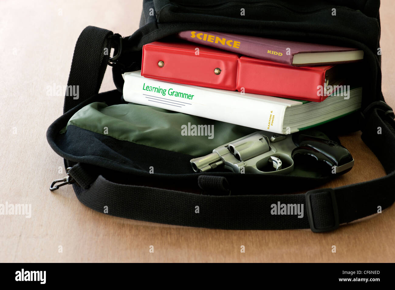 schoolbag with gun Stock Photo