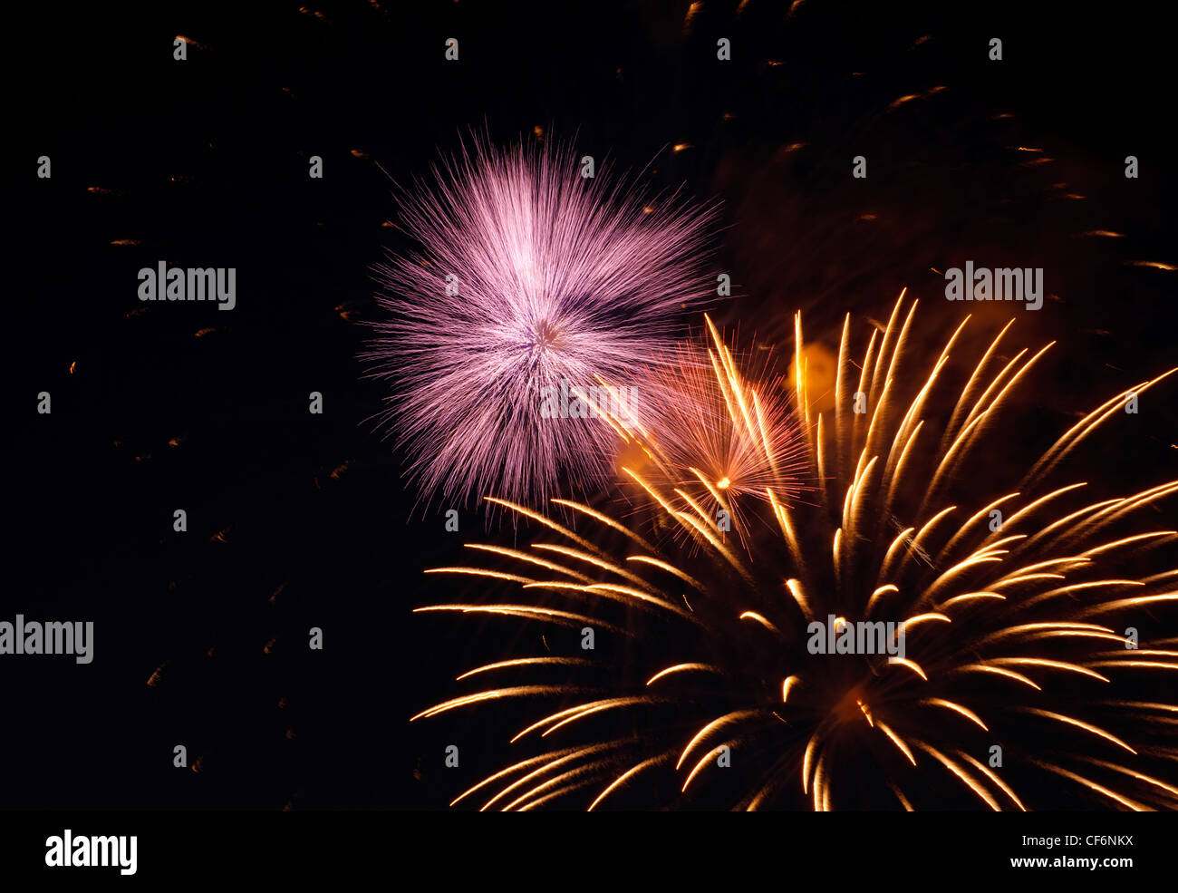 Pyrotechnic show. Bright fireworks explosions in the night sky. Stock Photo