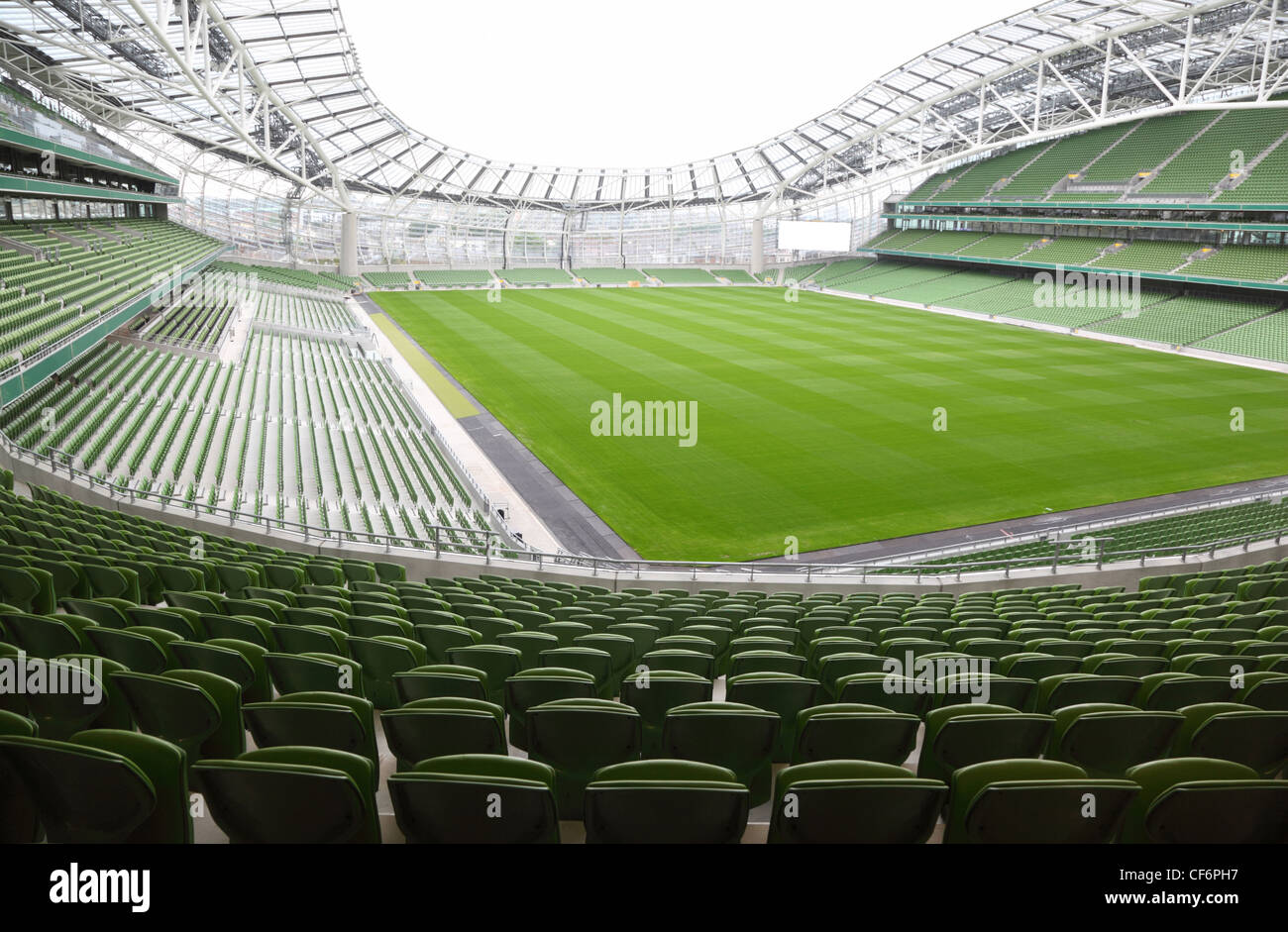 Rows of green seats in an empty stadium. Focus on front seats Stock Photo