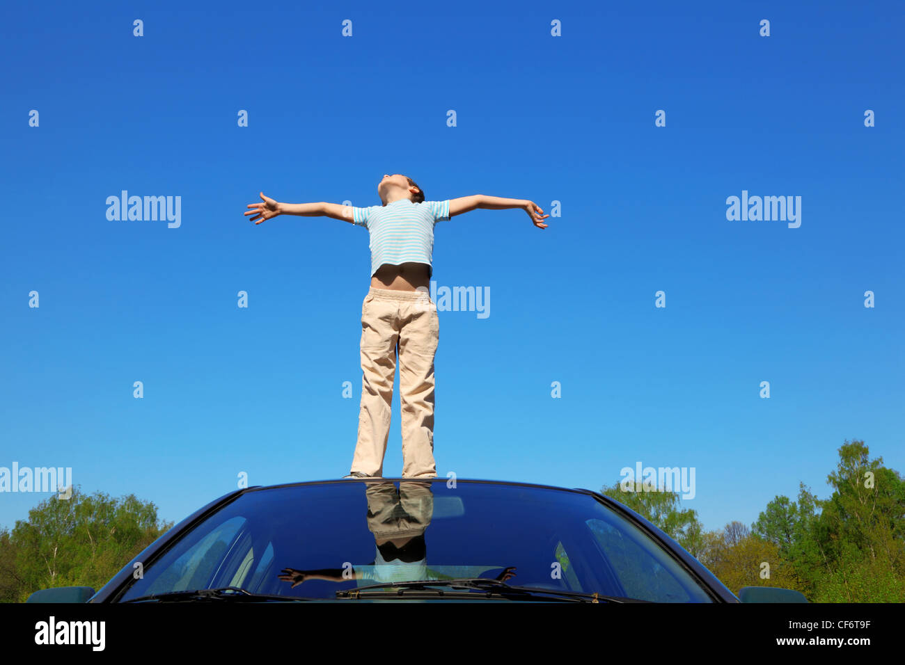 Boy standing on car roof hi-res stock photography and images - Alamy