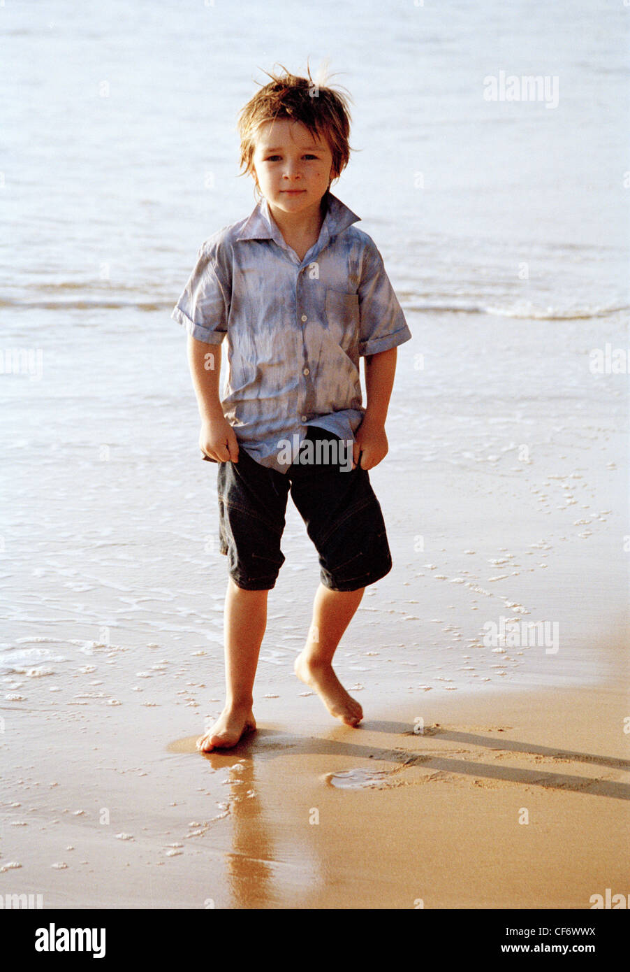 Male Child Wet Spiky Brown Hair Wearing White And Grey Tie Dye Shirt And Black Shorts Standing Looking To Camera Half Stock Photo Alamy