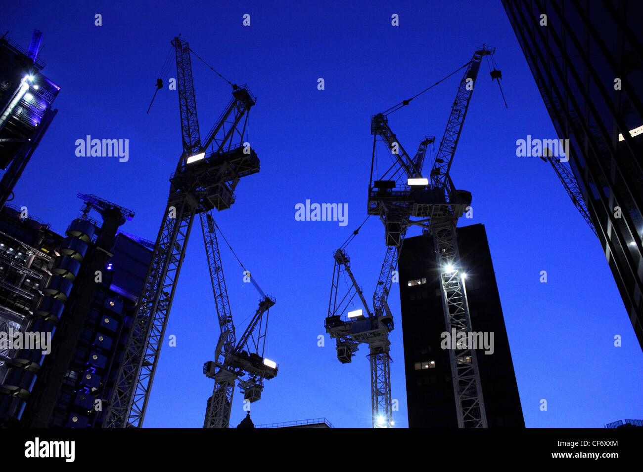 construction cranes at night Stock Photo