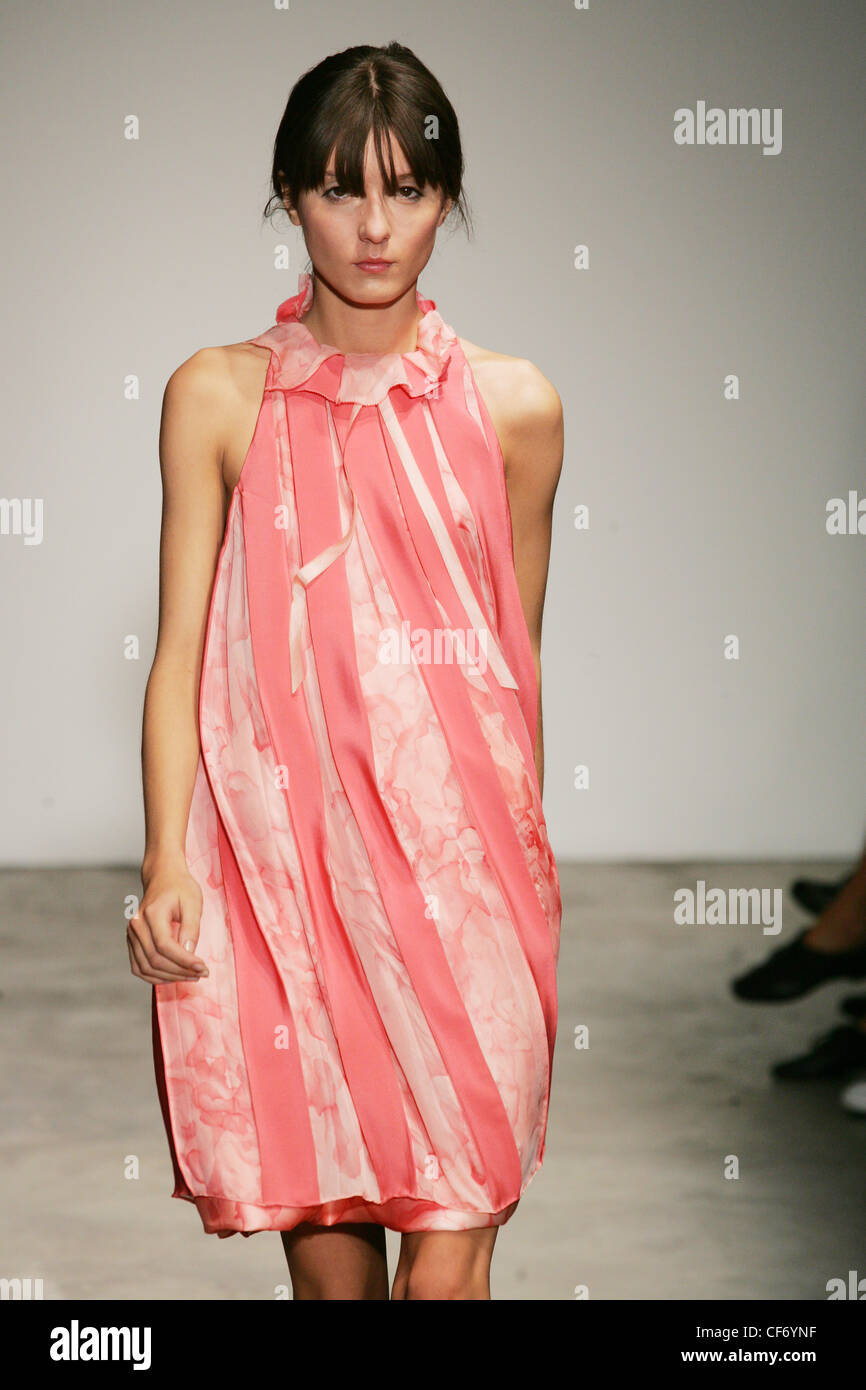 Thakoon New York Ready to Wear Spring Summer Model Irina Lazareanu wearing a pink bell shaped ribboned and layered dress Stock Photo