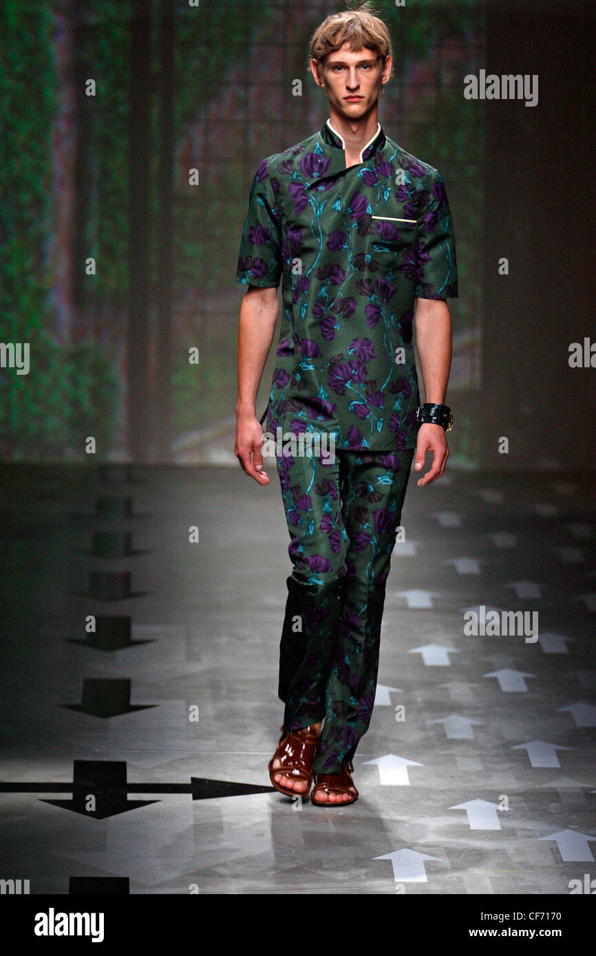 Prada Milan Menswear Ready to Wear Spring Summer Model wearing green short  sleeved shirt and trousers purple and blue floral Stock Photo - Alamy