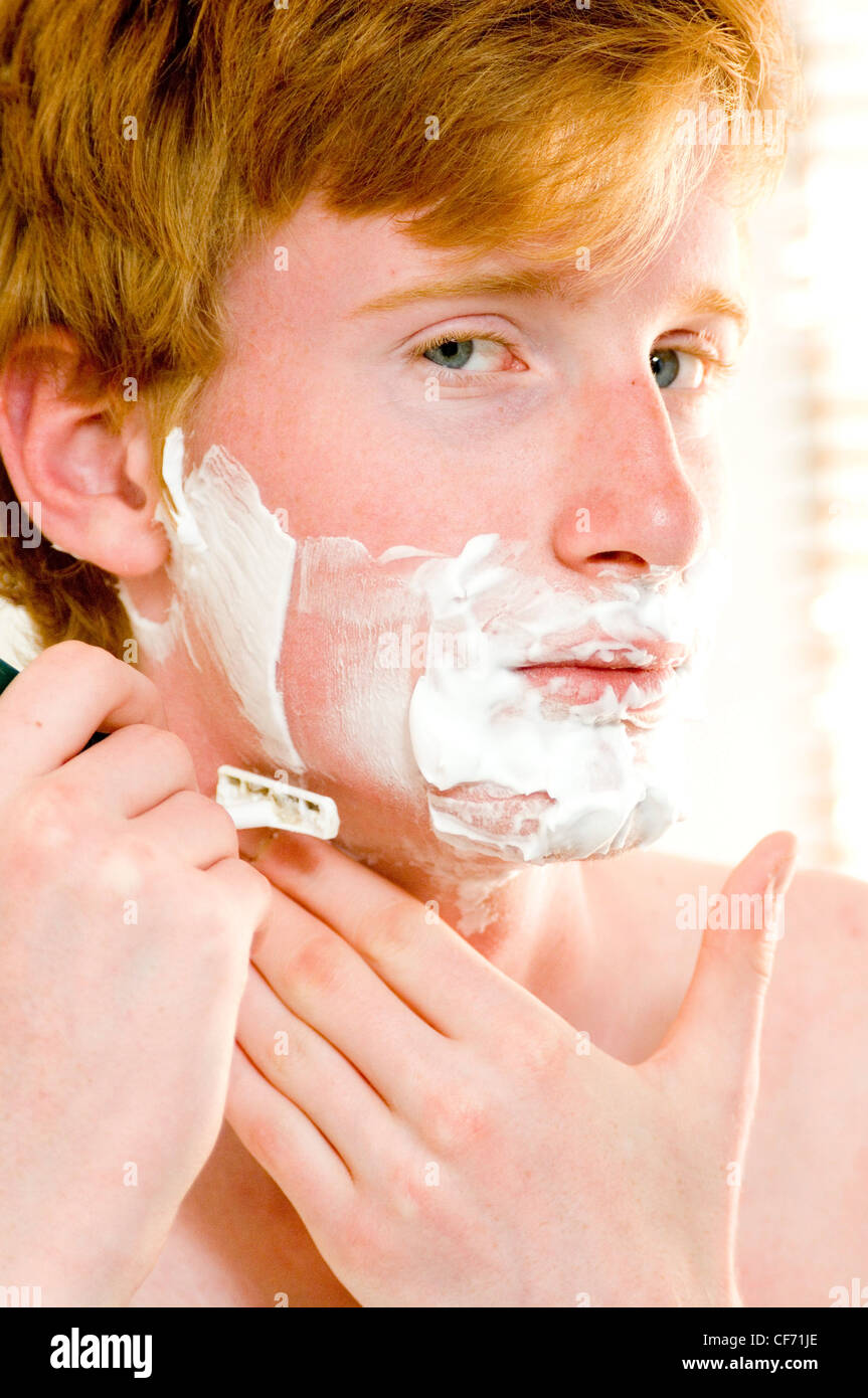 Male teenager shaving Stock Photo