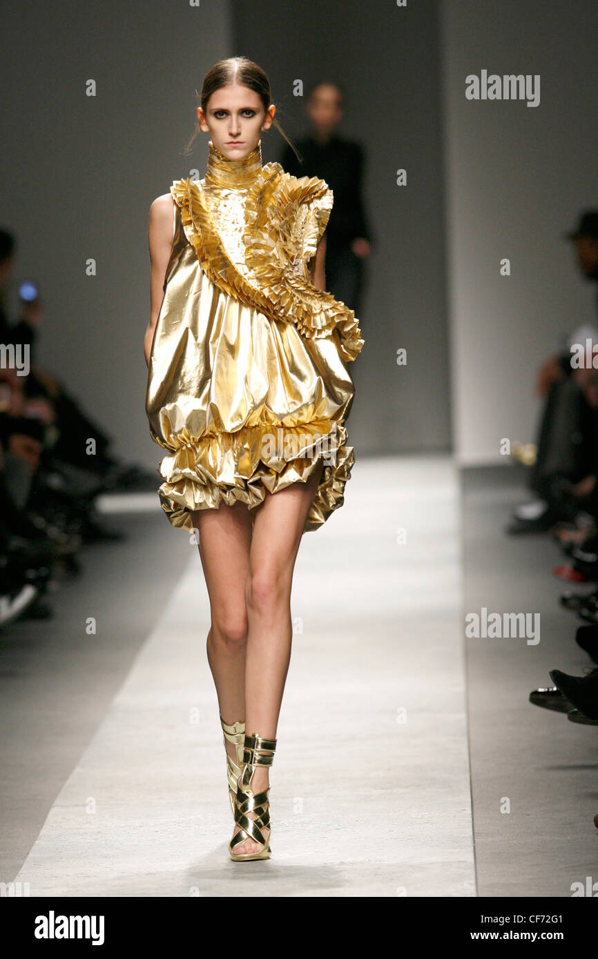 Givenchy Paris Ready to Wear Autumn Winter Metallic gold ruffled short dress,  with strappy gold sandals Stock Photo - Alamy