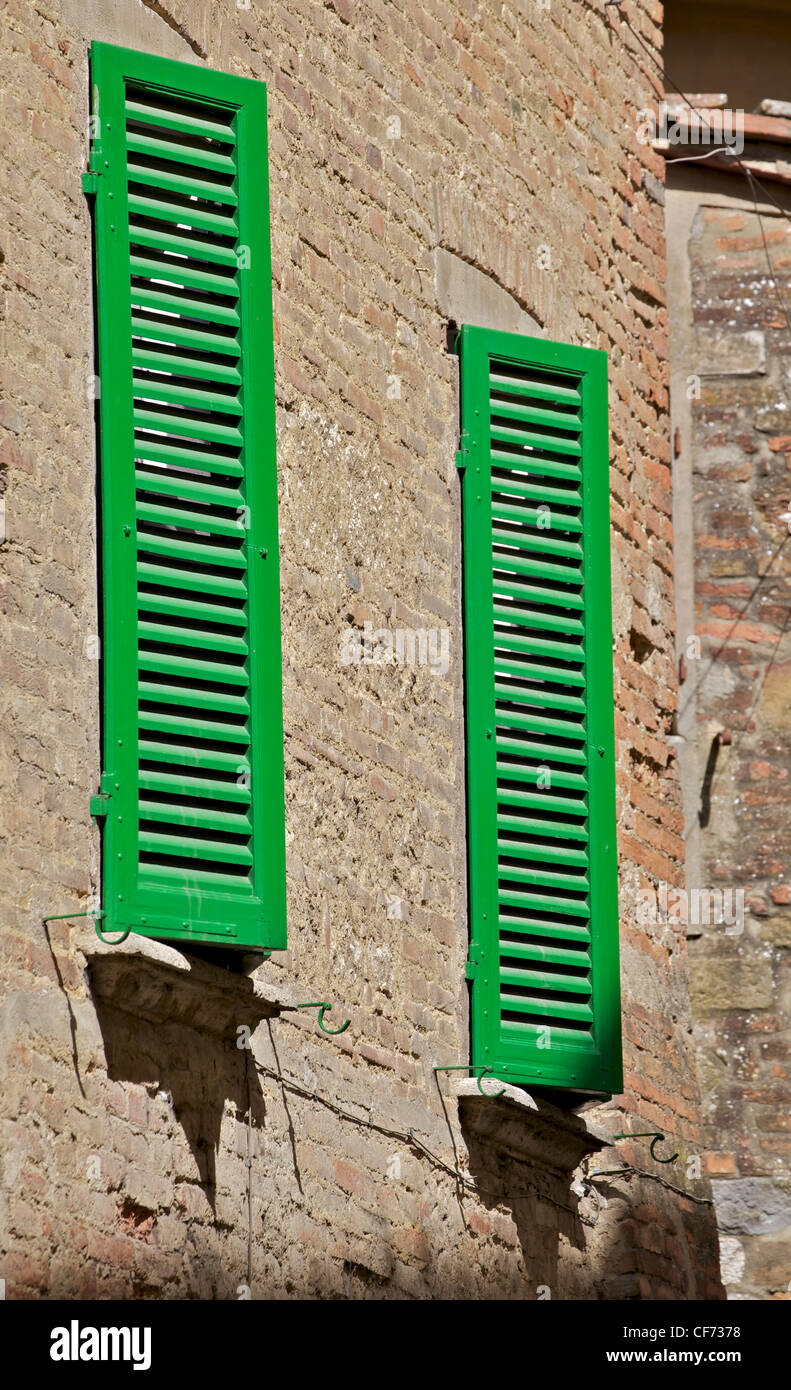 Green Wood Shutters on a Brick Wall in Tuscany Stock Photo