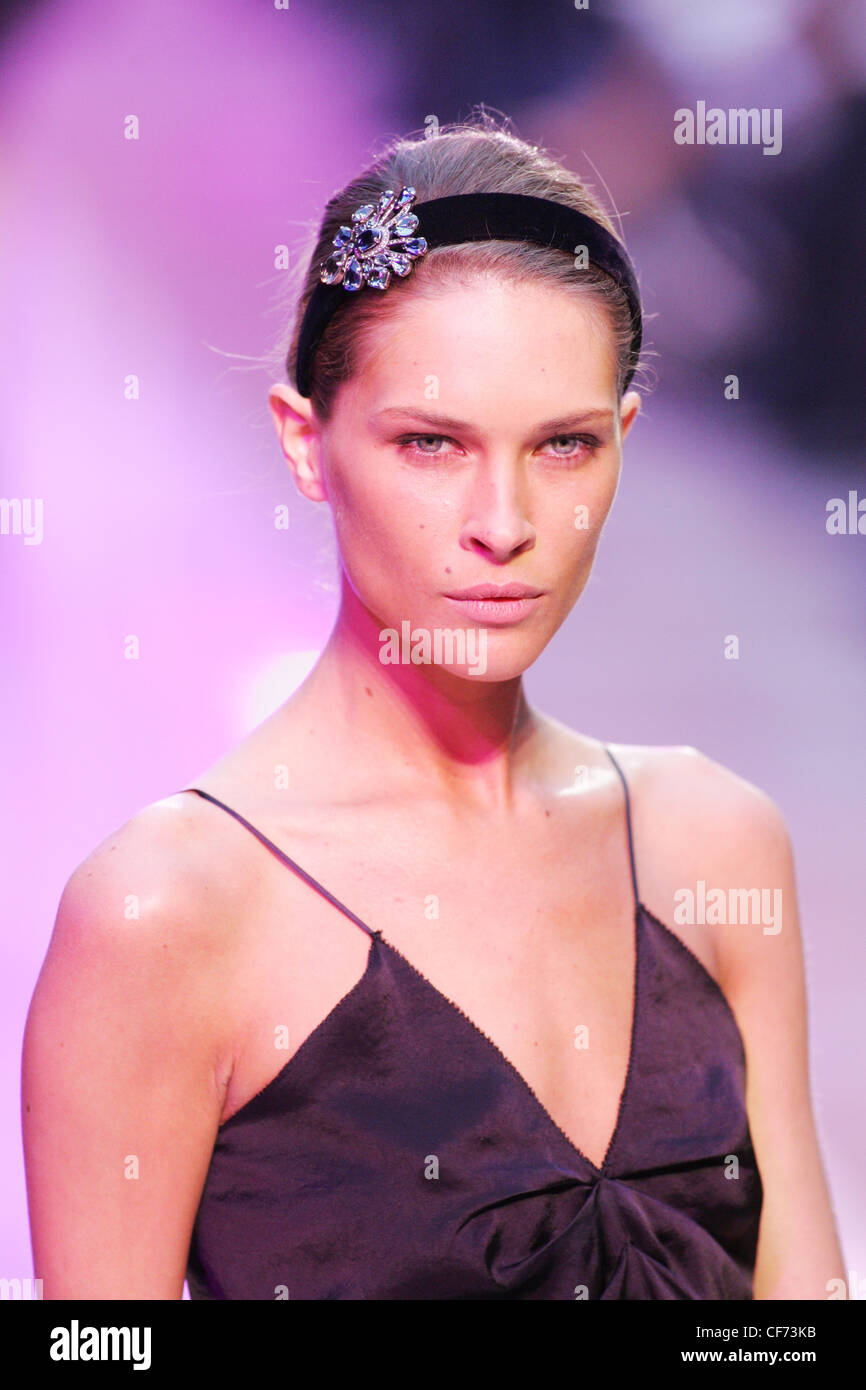 Louis Vuitton Paris Ready to Wear Spring Summer Model brunette hair wearing  black sparkly headband, red all in one swimsuit Stock Photo - Alamy