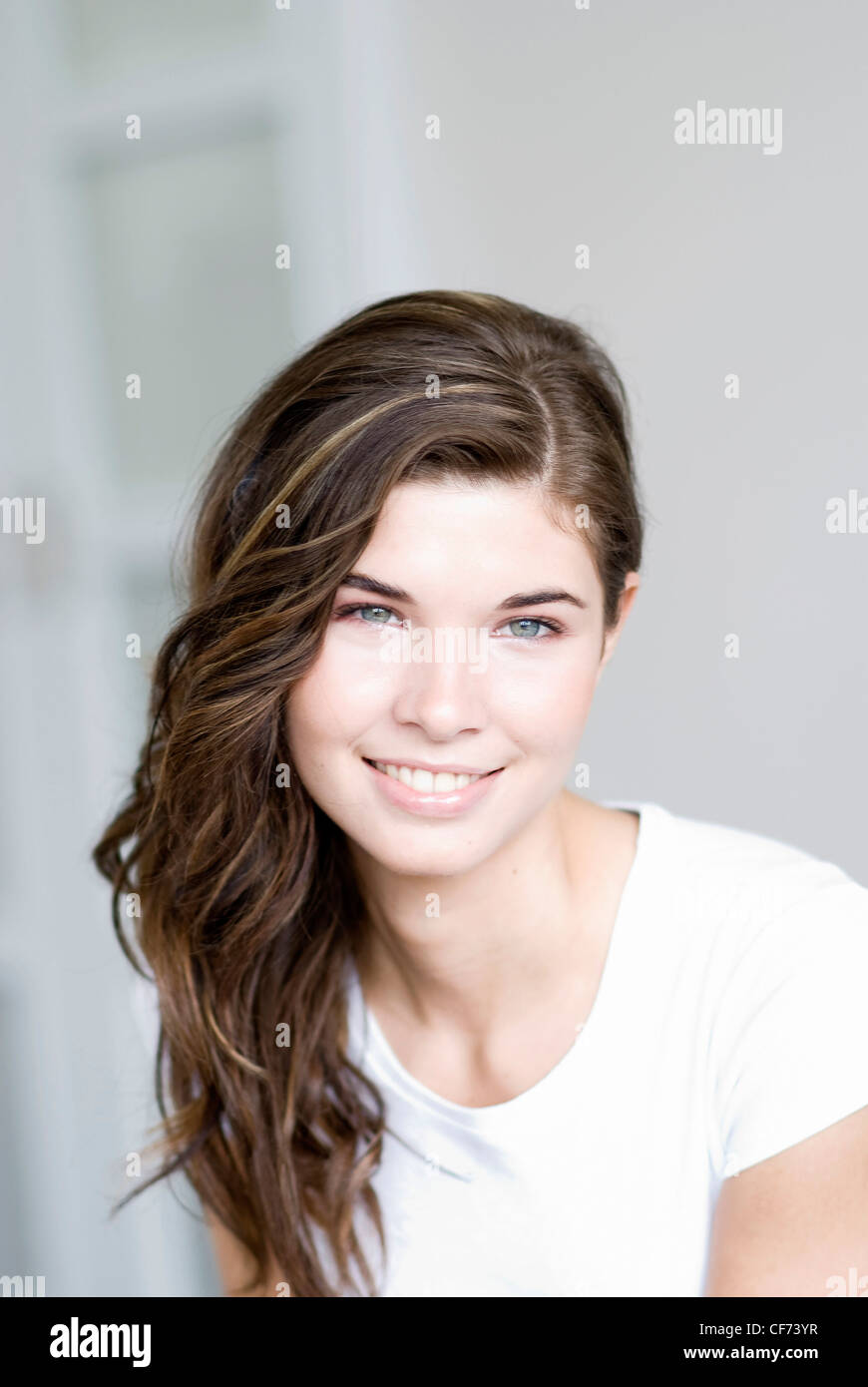 Female With Long Wavy Brunette Hair With Highlights Wearing A