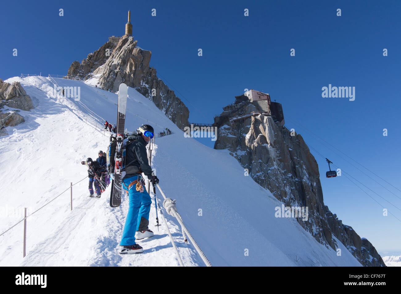 Man climbing down arete from aiguilles du midi cable car station