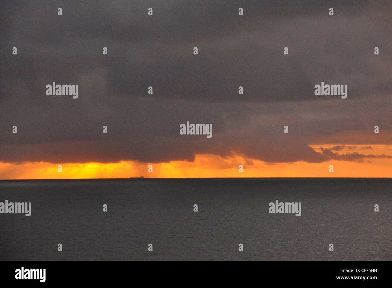 Black Sea Grey Sky orange clouds dramatic moody Stock Photo