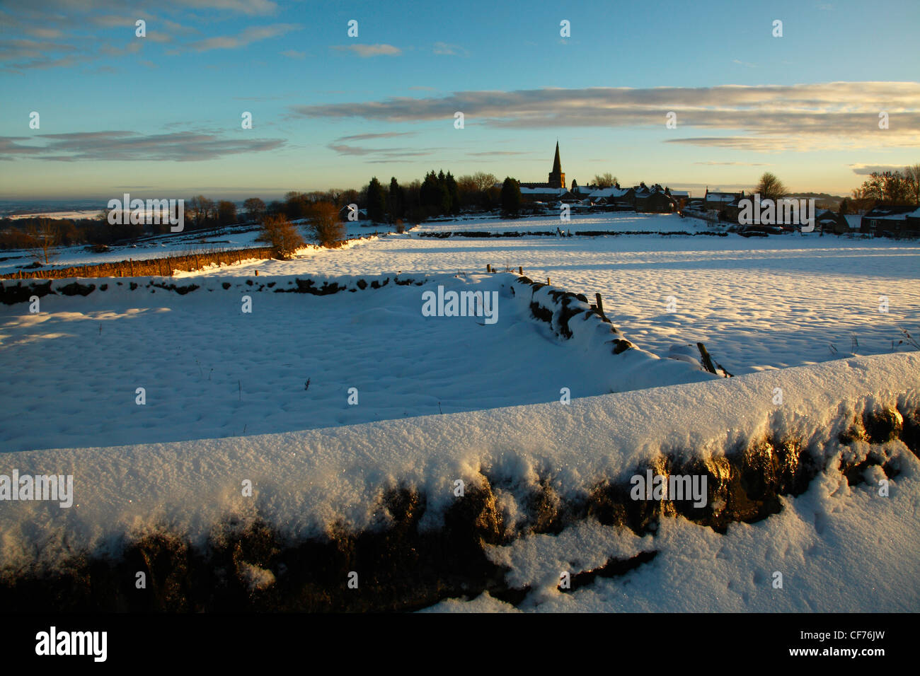 The Church of St Marys across the snow covered walls at Crich, Derbyshire. Stock Photo
