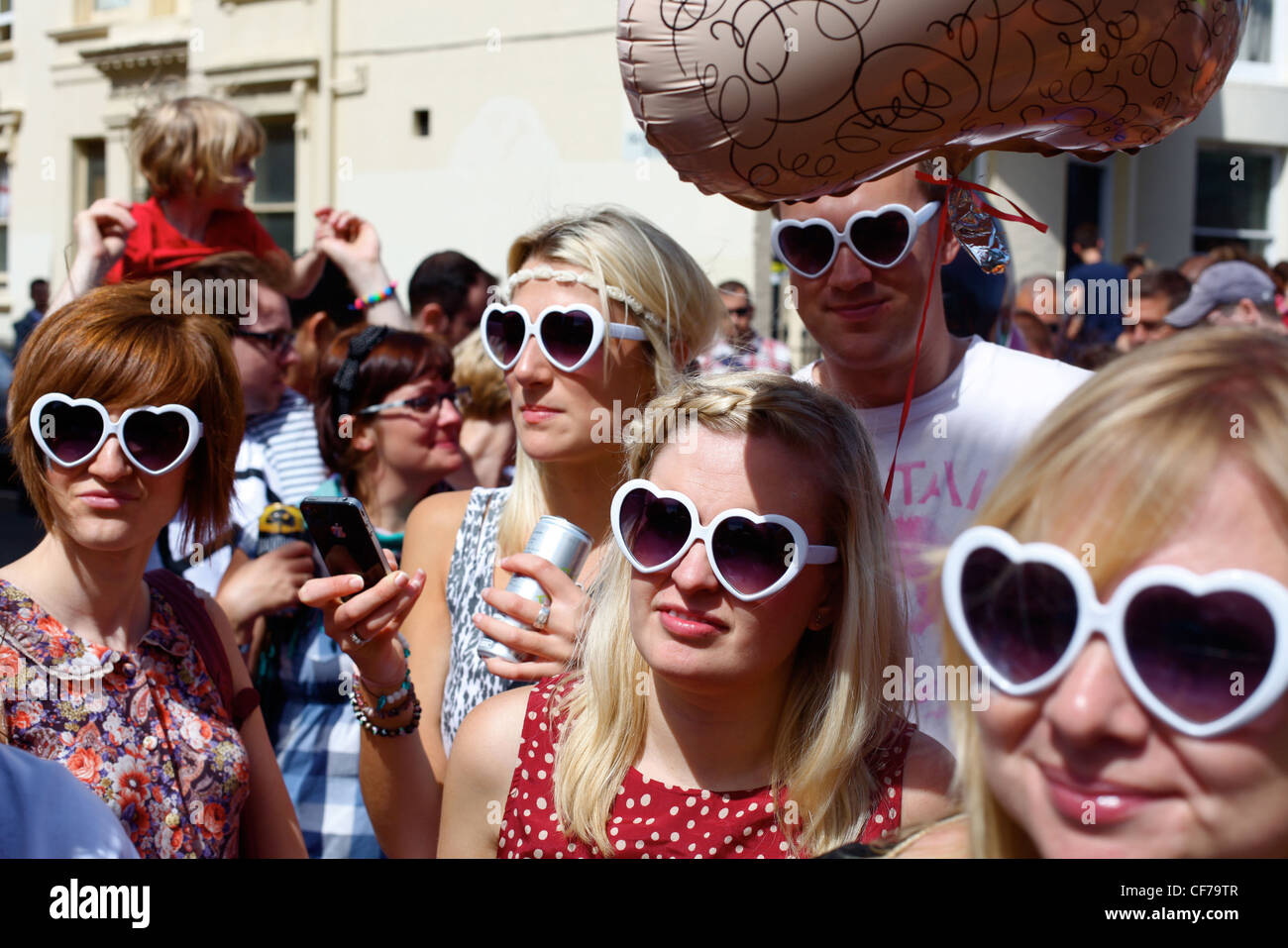 GROUP WEARING HEART SHAPED SUN GLASSES AT GAY PRIDE, BRIGHTON, UK Stock Photo