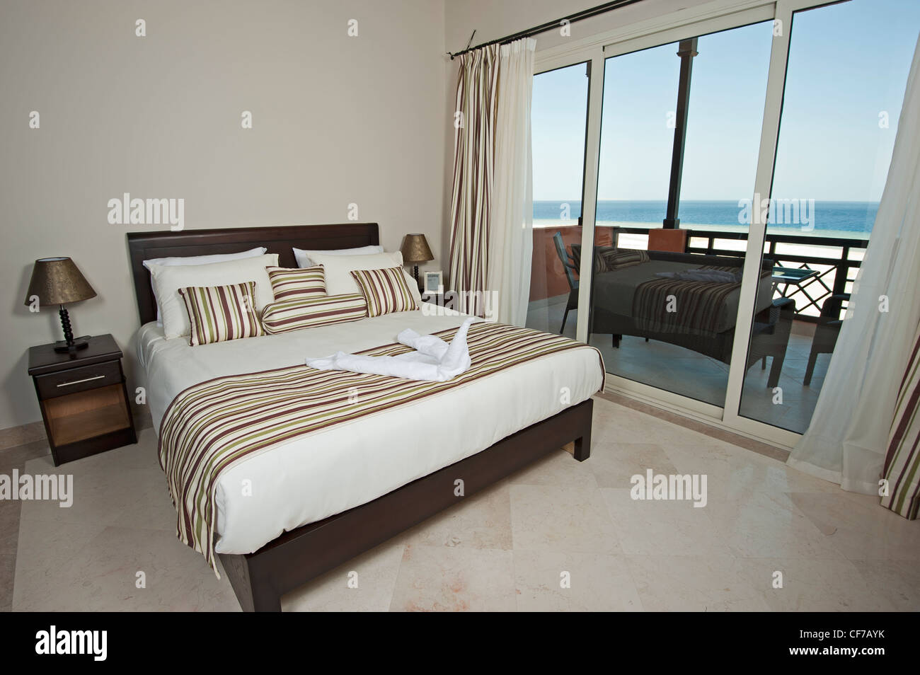 Bedroom on a luxury apartment with a tropical sea view Stock Photo